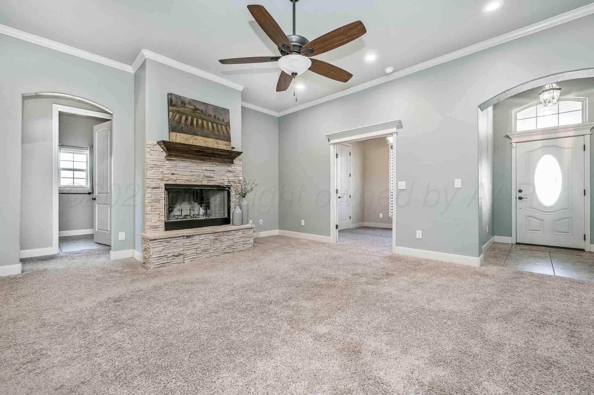 6 Cody Lane Canyon, TX 79015 - Photo 6 of 23 an empty room with fan and a fireplace