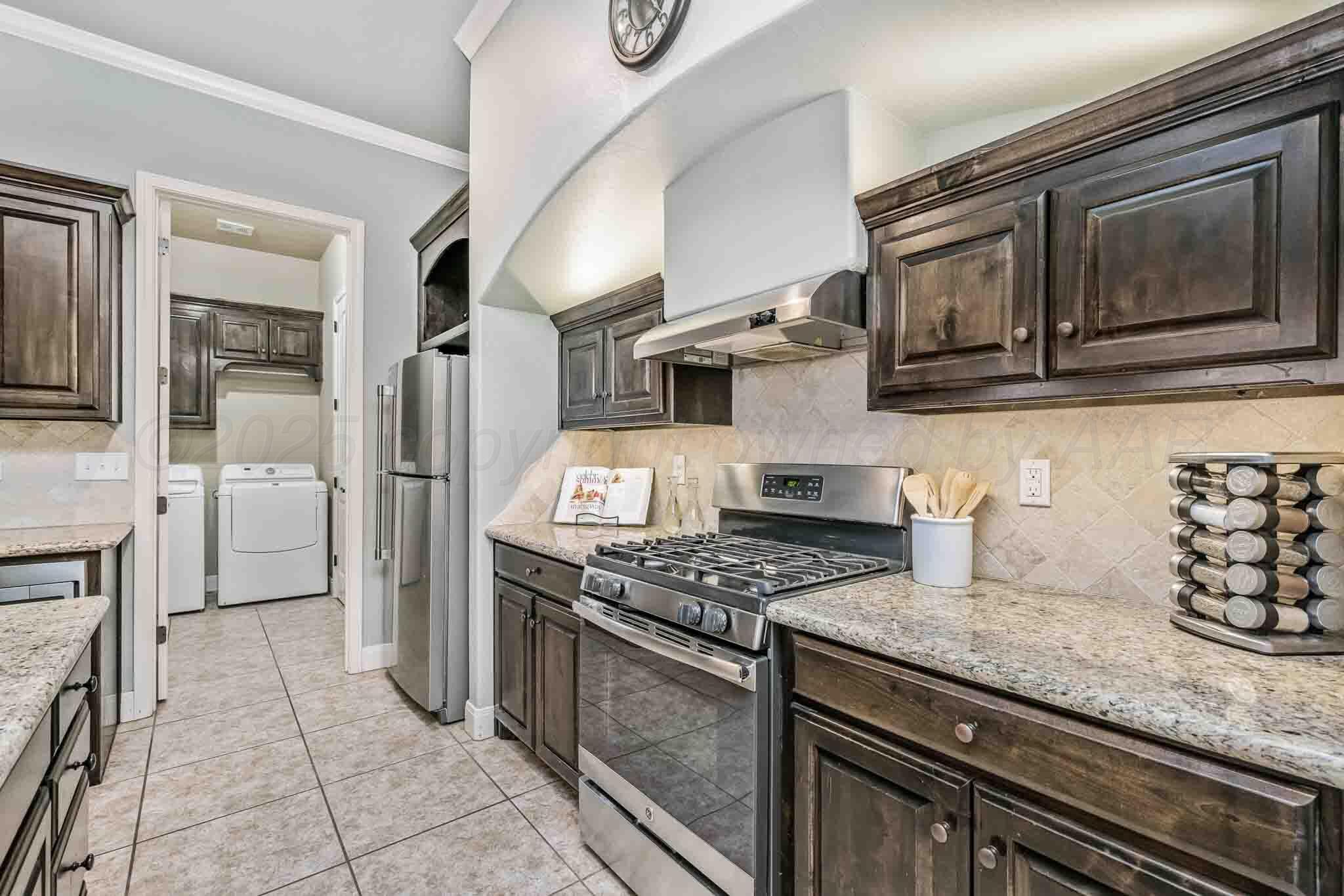 6 Cody Lane Canyon, TX 79015 - Photo 10 of 23 a kitchen with stainless steel appliances granite countertop a stove microwave and refrigerator