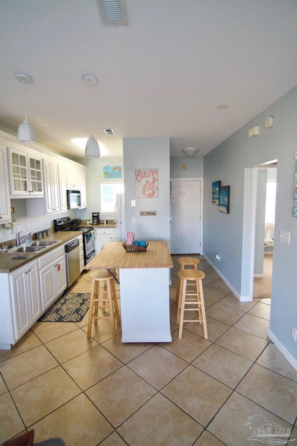 1150 Fort Pickens Road, Unit D7 Pensacola Beach, FL 32561 - Photo 5 of 19 a large white kitchen with a large window and stainless steel appliances