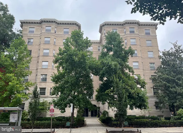 front view of a brick building next to a yard