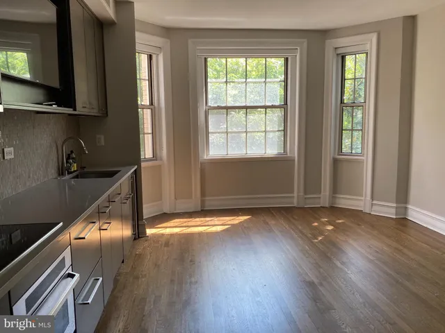 a kitchen with granite countertop white cabinets and stainless steel appliances