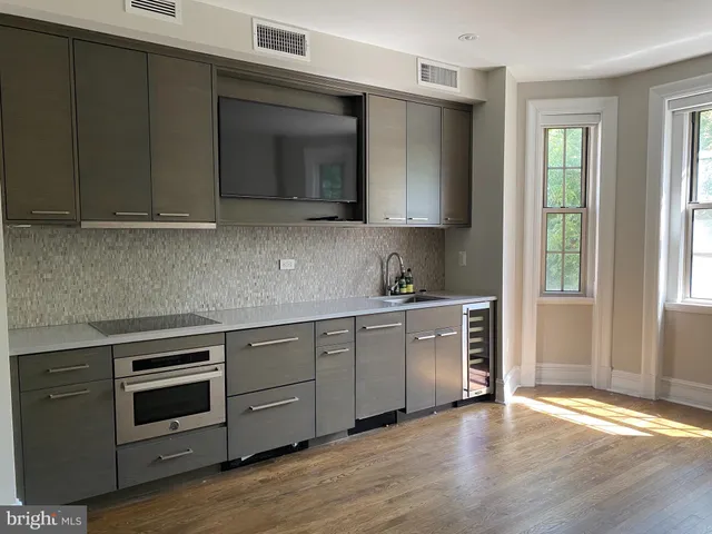 a kitchen with granite countertop white cabinets and stainless steel appliances