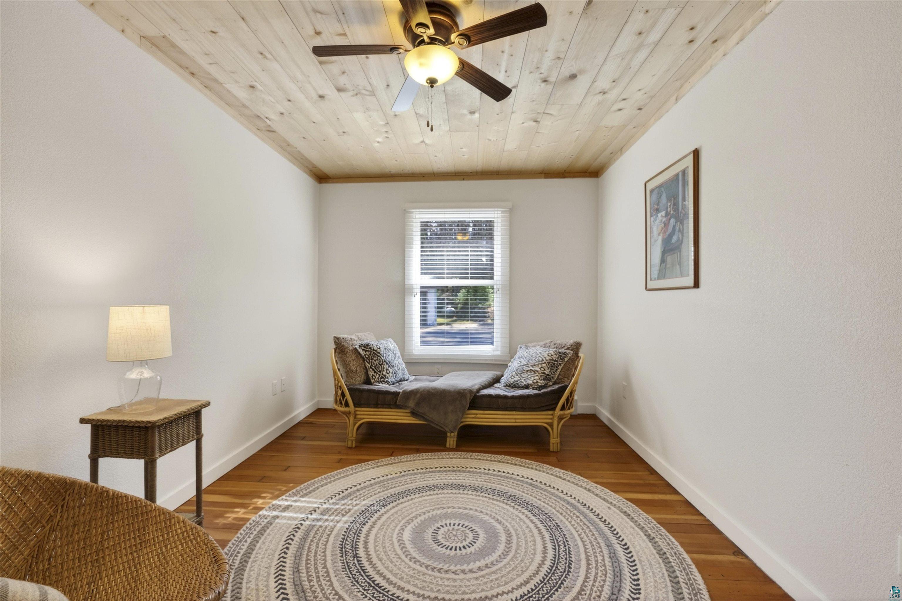 13885 Park Road Brule, WI 54820 - Photo 20 of 41 Room with light wood-finish flooring, a planked wood-finish ceiling, and a ceiling fan with integrated lighting
