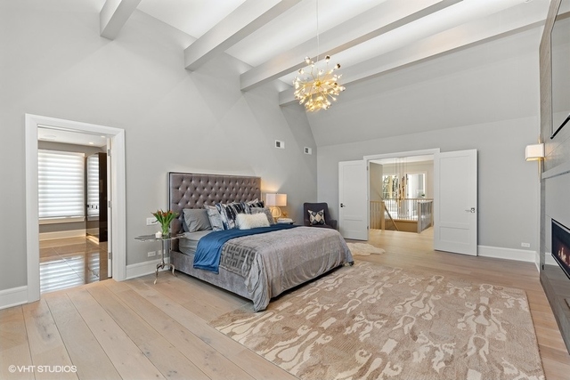 744 Taft Road Hinsdale, IL 60521 - Photo 25 of 37 a spacious bedroom with a large bed and a chandelier