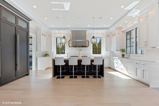 744 Taft Road Hinsdale, IL 60521 - Photo 9 of 37 a large kitchen with stainless steel appliances microwave a dining table and chairs