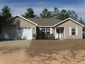 145 Laurel Lane DeFuniak Springs, FL 32433 - Photo 1 of 13 a front view of a house with a yard and garage