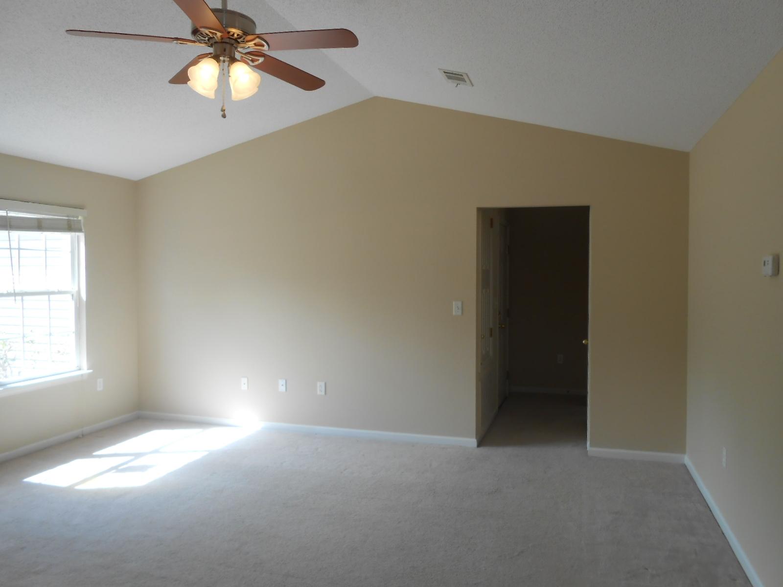 145 Laurel Lane DeFuniak Springs, FL 32433 - Photo 2 of 13 an empty room with windows and fan