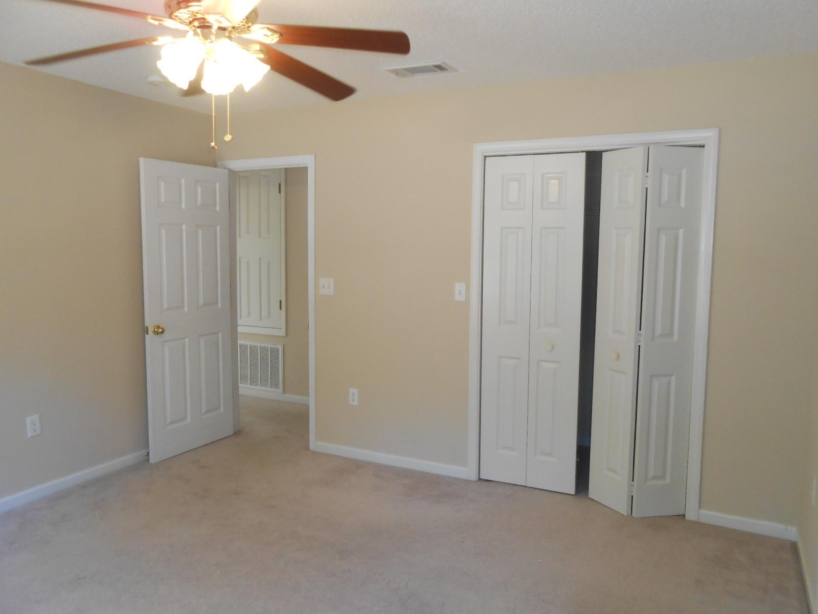 145 Laurel Lane DeFuniak Springs, FL 32433 - Photo 8 of 13 an empty room with windows and fan