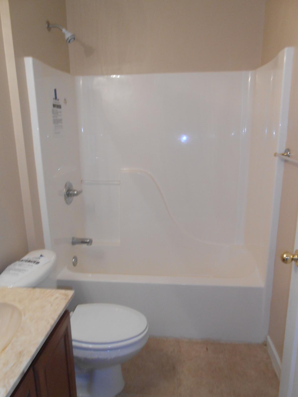 145 Laurel Lane DeFuniak Springs, FL 32433 - Photo 9 of 13 a bathroom with a granite countertop sink toilet and shower