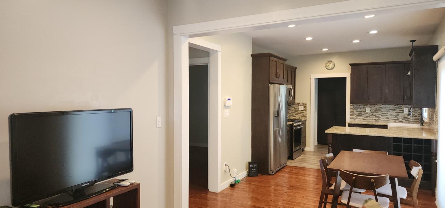 690 Madison Street Santa Clara, CA 95050 - Photo 5 of 27 a dining room with furniture and a flat screen tv