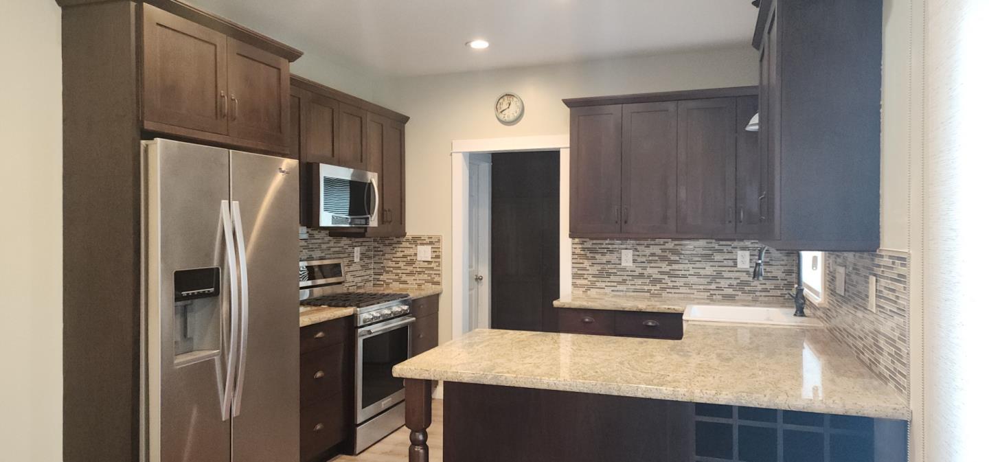 690 Madison Street Santa Clara, CA 95050 - Photo 6 of 27 a kitchen with kitchen island a counter space and refrigerator