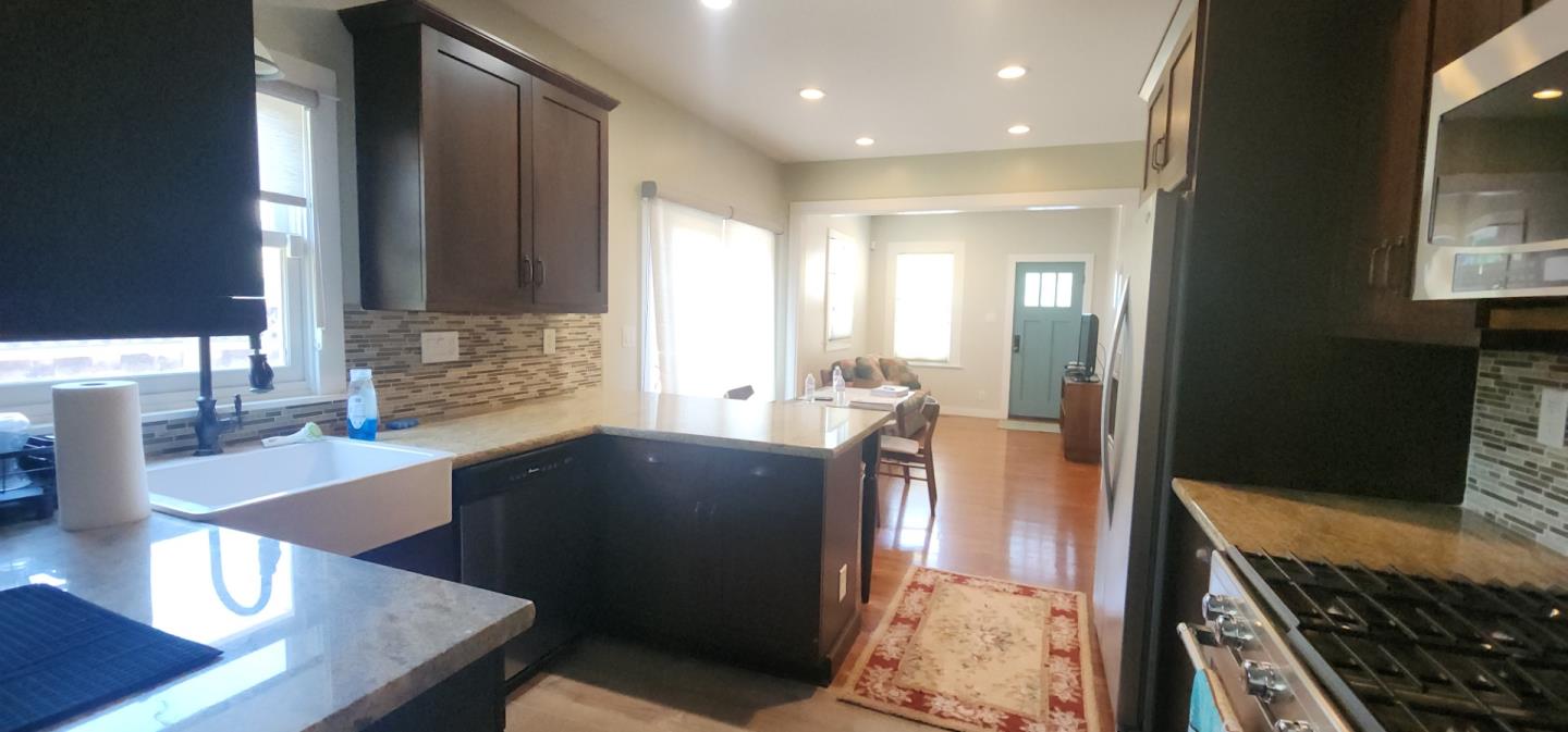 690 Madison Street Santa Clara, CA 95050 - Photo 8 of 27 a kitchen with stainless steel appliances wooden cabinets and a stove top oven