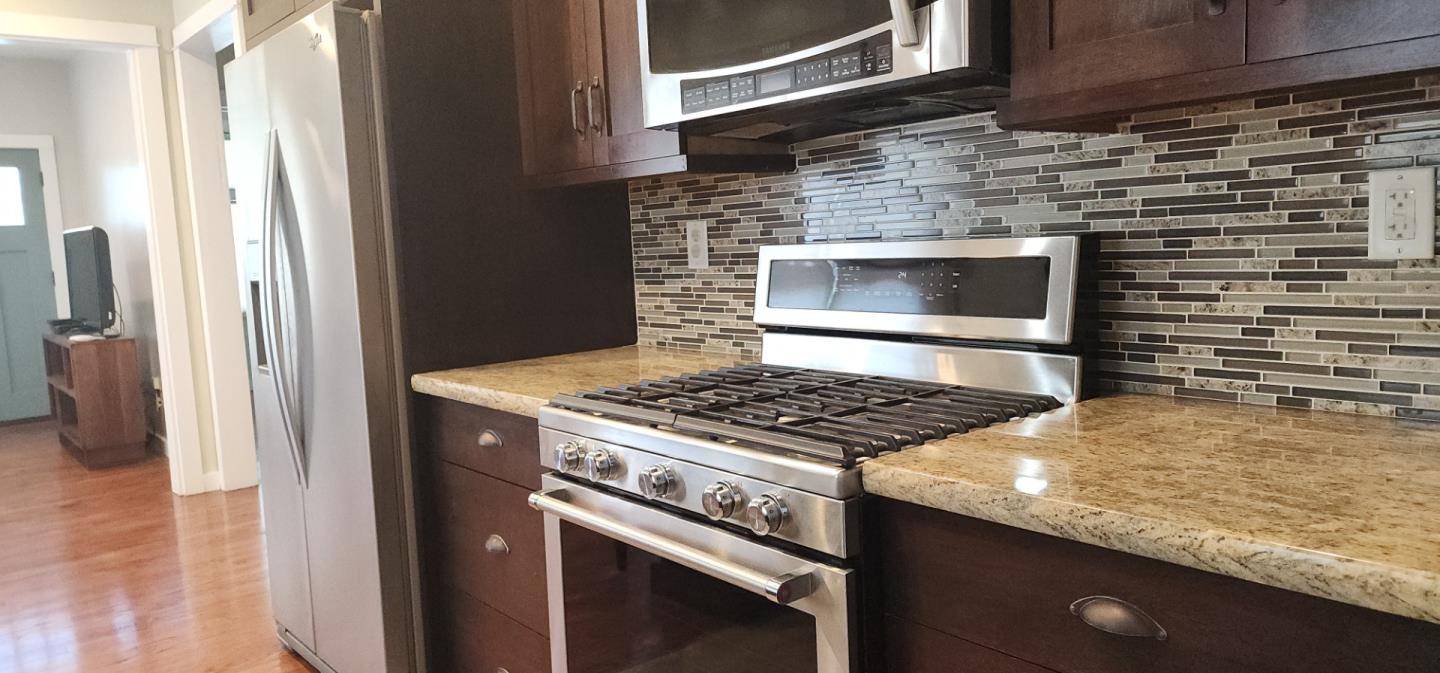 690 Madison Street Santa Clara, CA 95050 - Photo 9 of 27 a stove top oven sitting inside of a kitchen