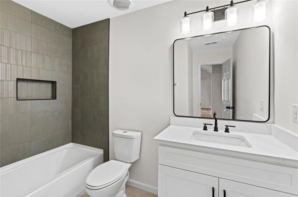 4095 Arch Pass Cumming, GA 30040 - Photo 17 of 31 a bathroom with a sink a toilet and shower