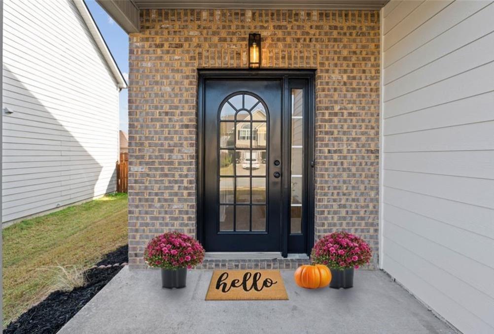 4095 Arch Pass Cumming, GA 30040 - Photo 2 of 31 a front view of a house with a large window and potted plants