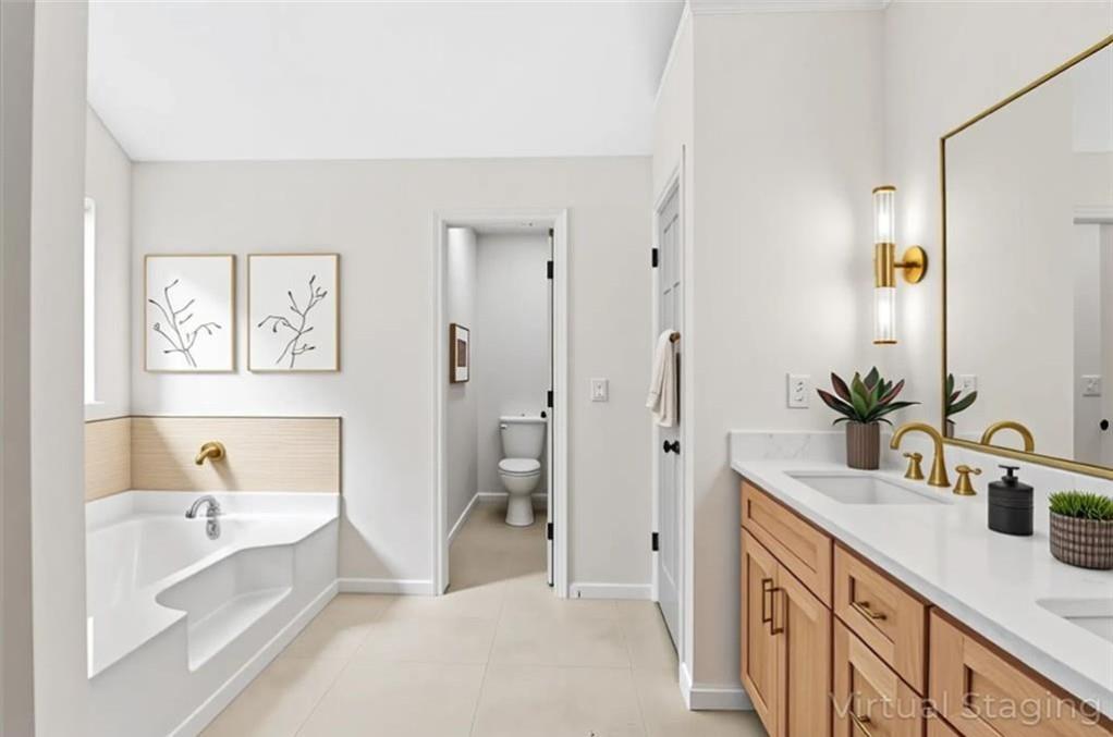 4095 Arch Pass Cumming, GA 30040 - Photo 26 of 31 a spacious bathroom with a tub sink and mirror