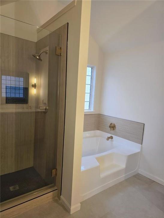 4095 Arch Pass Cumming, GA 30040 - Photo 27 of 31 a bathroom with a bathtub and a shower