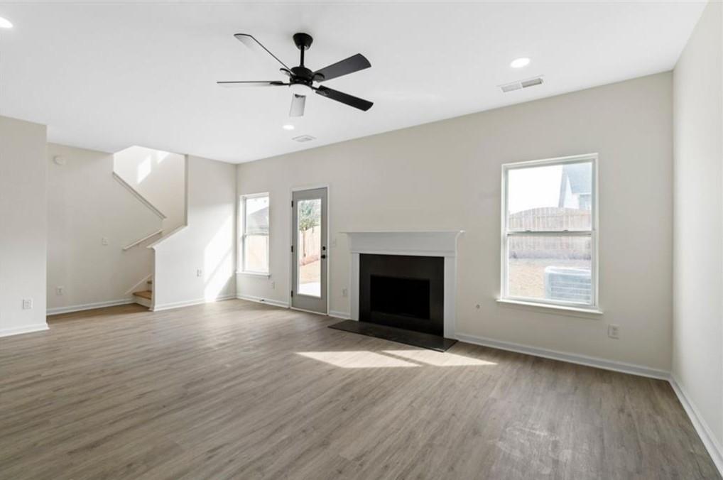 4095 Arch Pass Cumming, GA 30040 - Photo 10 of 31 a view of an empty room with wooden floor fireplace and a window