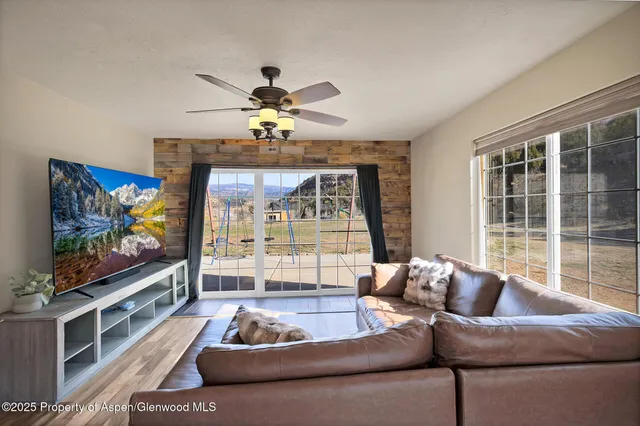 a living room with furniture and a flat screen tv
