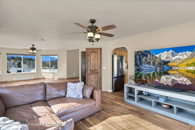 a living room with furniture and a flat screen tv