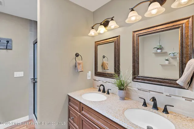 a bathroom with a double vanity sink and a mirror