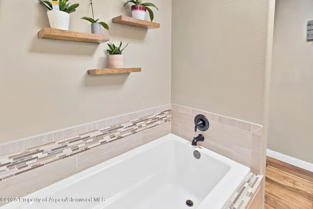 a bathroom with a white tub and sink