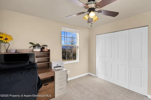 a workspace with furniture and chandelier