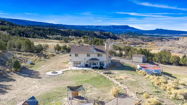 a view of a terrace with lawn chairs