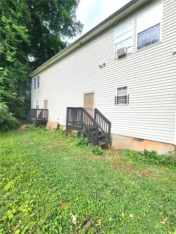 a backyard of a house with table and chairs
