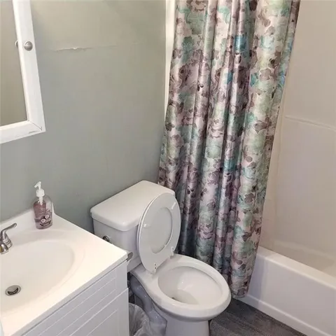 a white toilet sitting next to a bathroom sink
