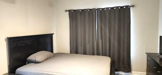 a bedroom with a bed and a tv