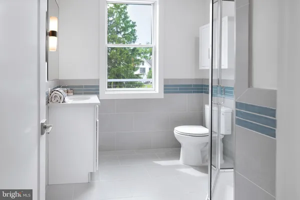 a bathroom with a toilet sink and a shower