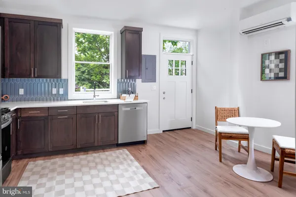a kitchen with a sink cabinets and wooden floor
