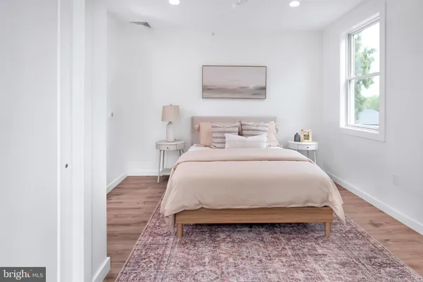 a bedroom with a bed and a wall painting