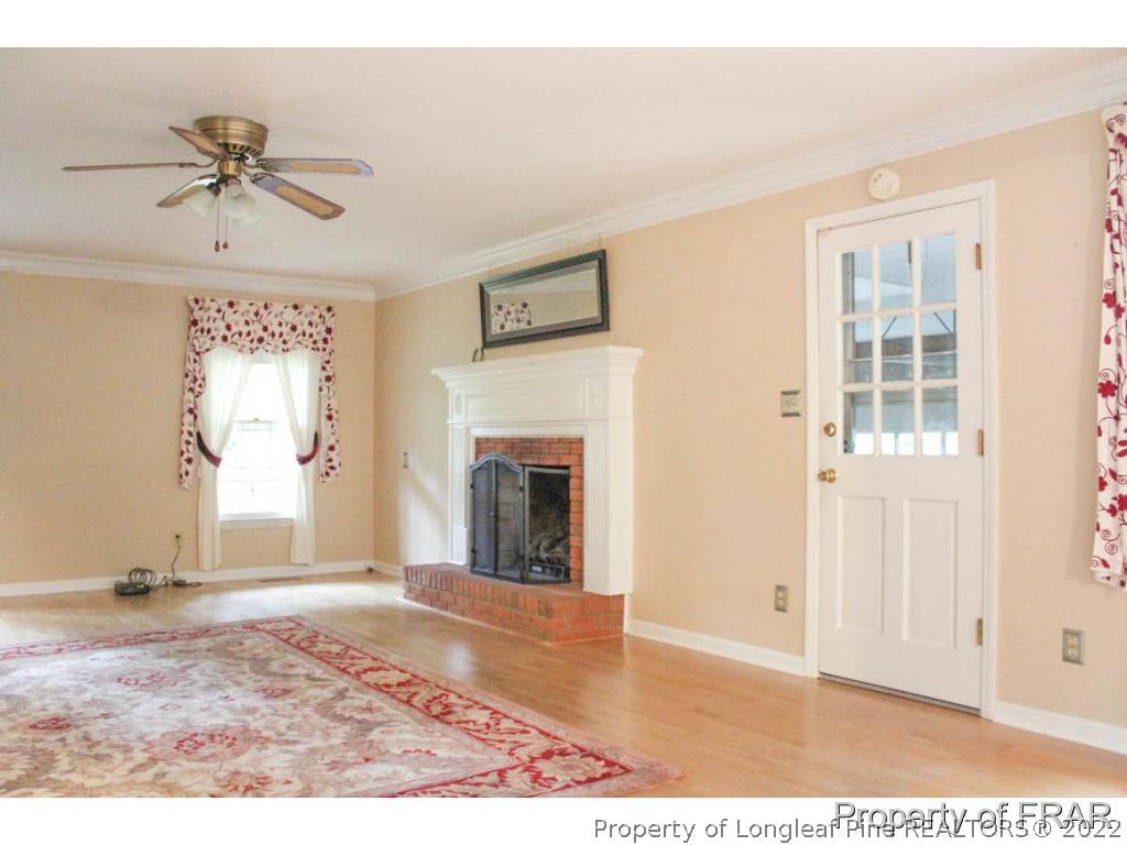 708 Garden Road Aberdeen, NC 28315 - Photo 9 of 25 a view of a livingroom with a fireplace and window
