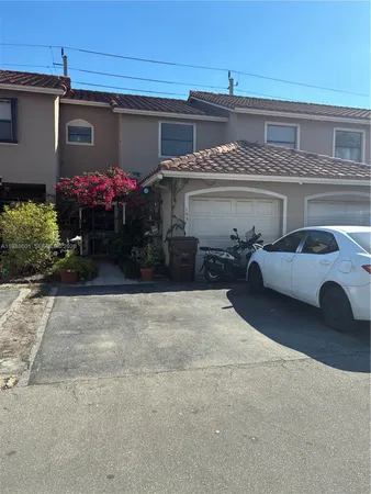 a view of a car park in front of a house