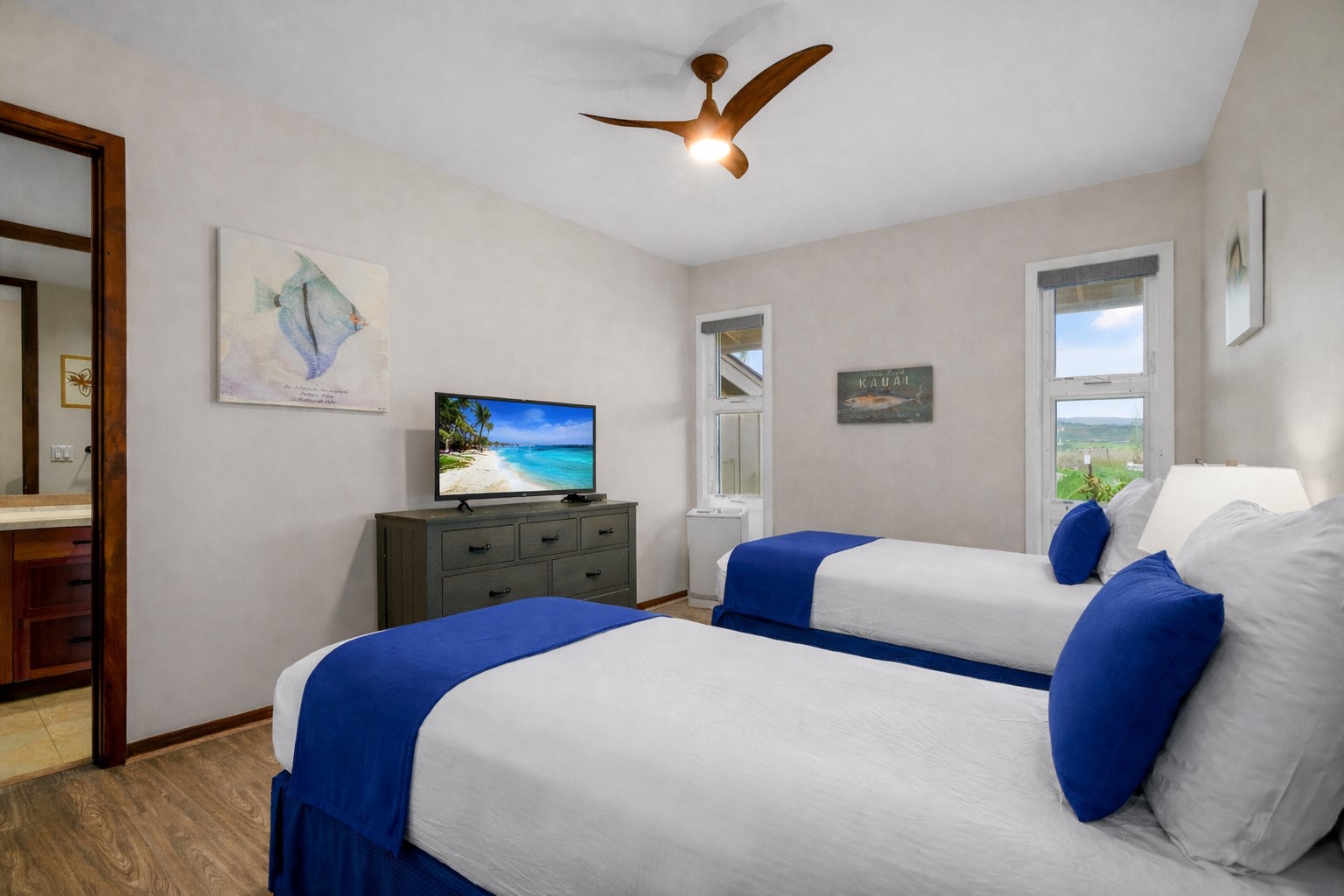 2640 Puuholo Road, Unit 231 Koloa, HI 96756 - Photo 19 of 30 a bedroom with a bed and wooden floor