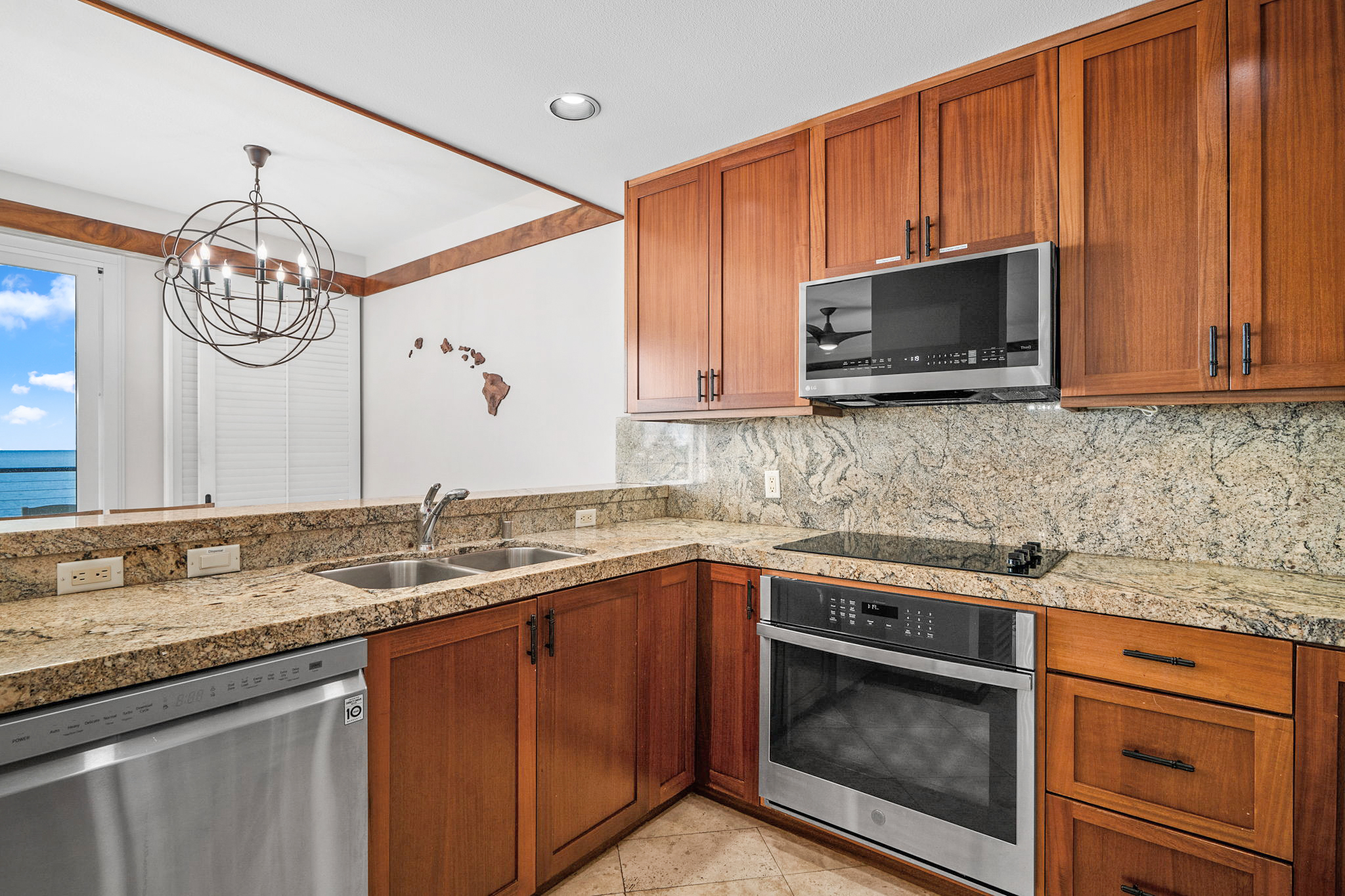 2640 Puuholo Road, Unit 231 Koloa, HI 96756 - Photo 3 of 30 a kitchen with stainless steel appliances granite countertop a sink a stove microwave and cabinets