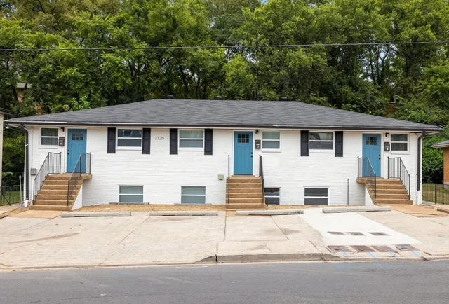 a house that has a tree in front of it