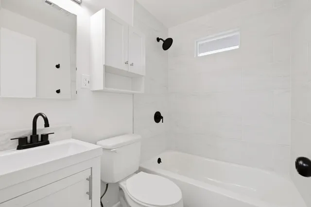 a bathroom with a sink toilet and bathtub