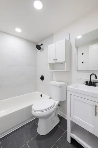 a bathroom with a sink a toilet and a bathtub