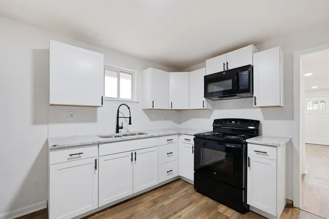 a kitchen with a sink and a stove top oven