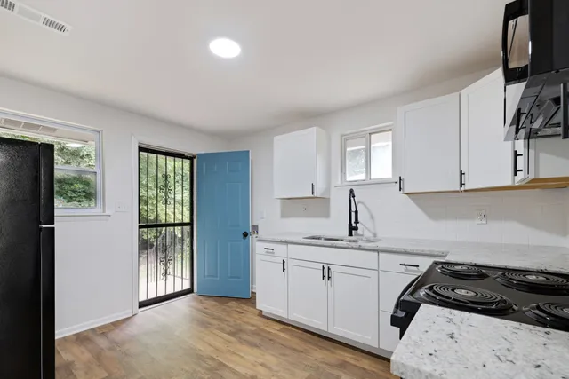 a kitchen with a sink stove and refrigerator