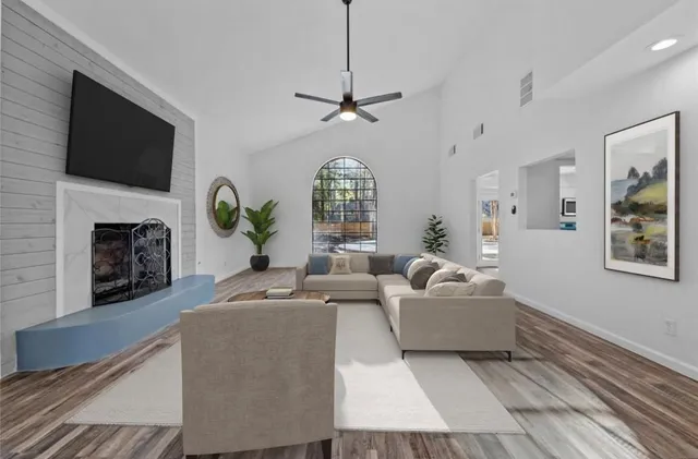 a living room with fireplace furniture and a flat screen tv