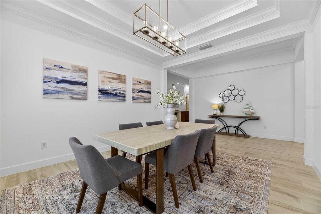 994 Signet Drive Apollo Beach, FL 33572 - Photo 14 of 98 a view of a dining room with furniture and chandelier