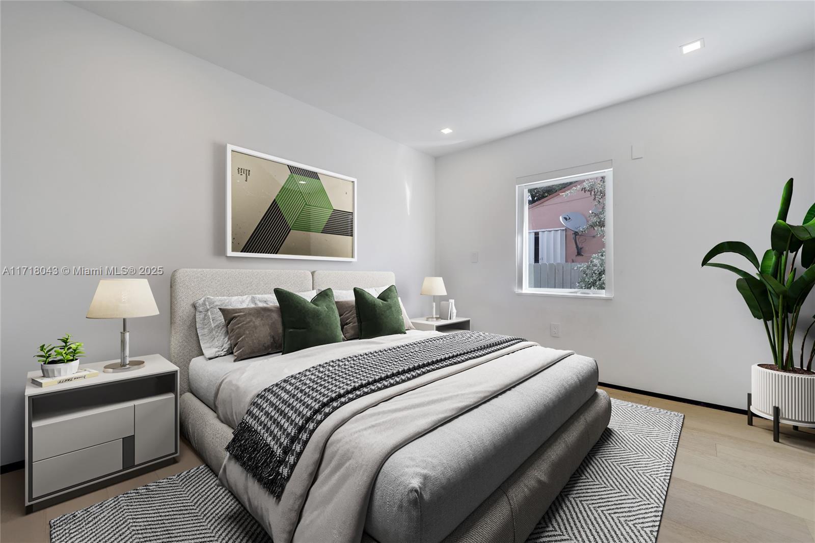 2725 Southwest 19th Street Miami, FL 33145 - Photo 11 of 49 a bedroom with a bed and a potted plant