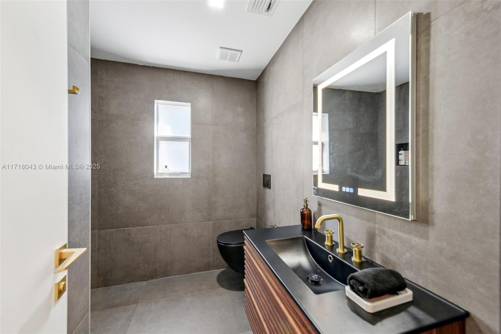 2725 Southwest 19th Street Miami, FL 33145 - Photo 12 of 49 a bathroom with a sink and a mirror