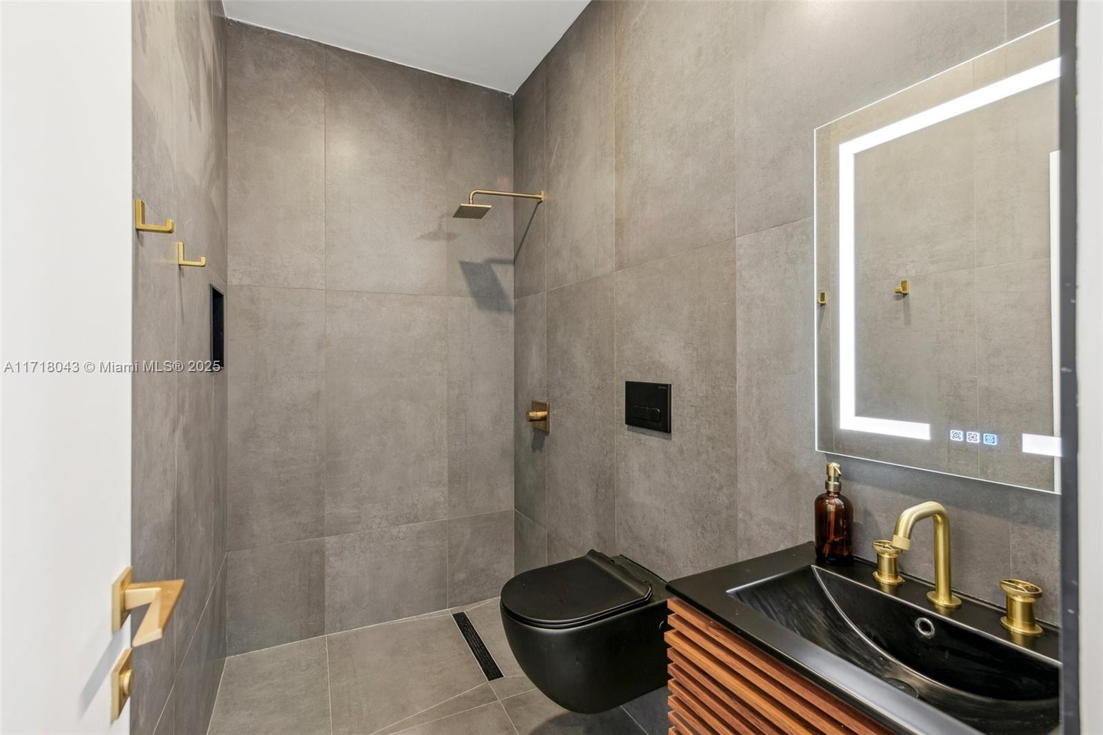 2725 Southwest 19th Street Miami, FL 33145 - Photo 15 of 49 a bathroom with a granite countertop sink a toilet and shower