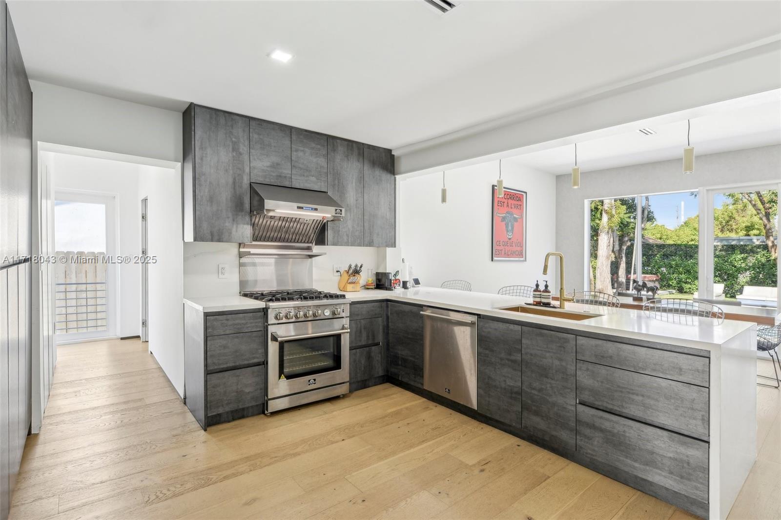 2725 Southwest 19th Street Miami, FL 33145 - Photo 18 of 49 a kitchen with stainless steel appliances granite countertop a stove and a sink