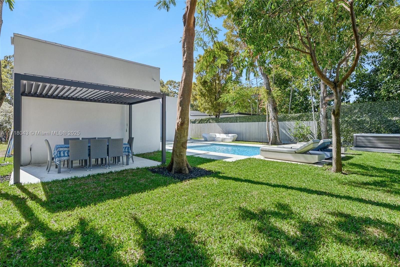 2725 Southwest 19th Street Miami, FL 33145 - Photo 38 of 49 a view of a patio with a table chairs and a small yard